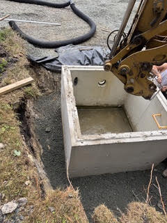 Setting a precast stormwater structure with an excavator on Maryland's Eastern Shore