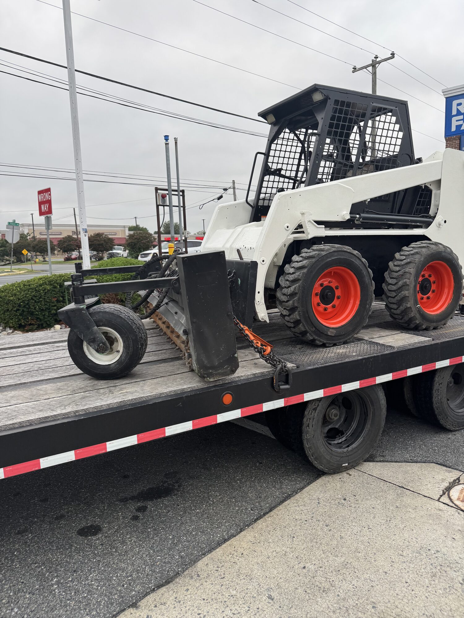 Marshy Hope Construction's skid steer loaded and chained on the equipment trailer