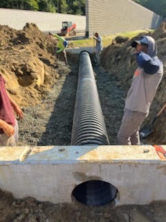 Marshy Hope Construction crew setting storm drain pipe on a commercial site in Dorchester County, Maryland