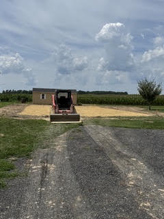 Skid steer spreading stone for a farm equipment pad on Maryland's Eastern Shore
