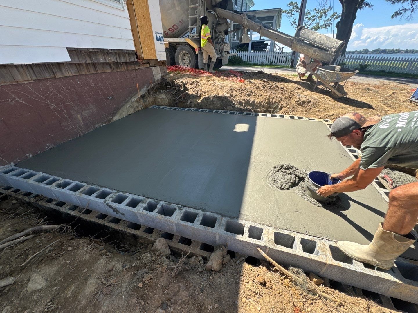 Marshy Hope Construction pouring and finishing a concrete slab inside a block foundation in Dorchester County, Maryland